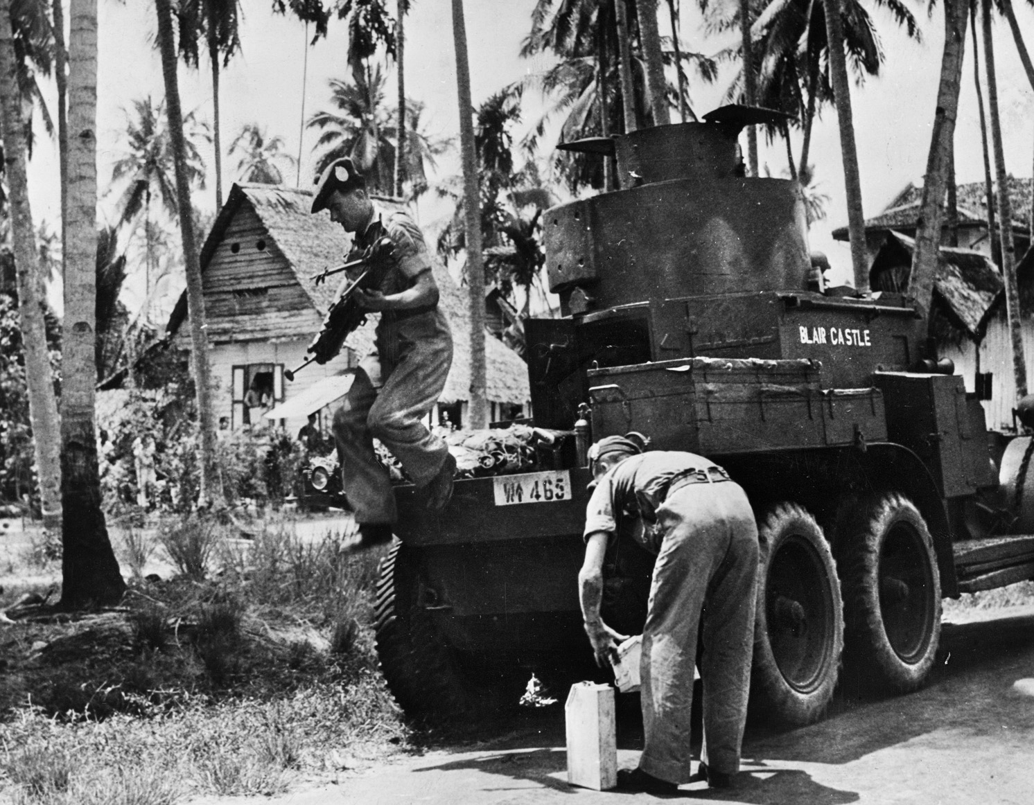 British forces were without armored support during their defense of the Malay Peninsula. Only a few obsolete armored cars were available, and they were of little use against the Japanese tanks. In this photo, soldiers of the Argyll and Sutherland Highlander Regiment patrol in company with a Lanchester armored car.