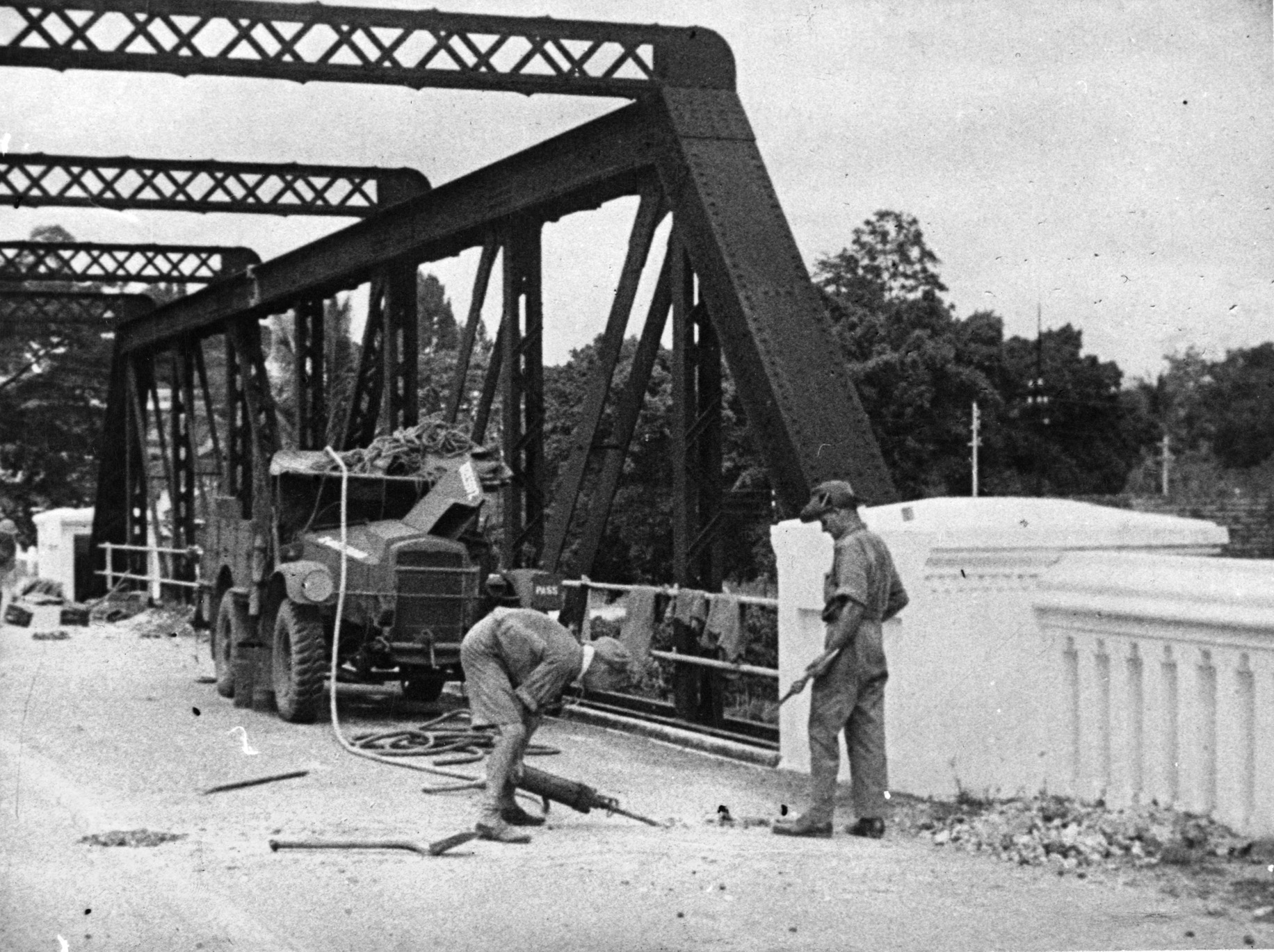 In preparation for the coming Japanese onslaught, British sappers lay explosive charges to destroy a bridge at Seremban along a probable route of enemy advance near Kuala Lumpur in late 1941. 