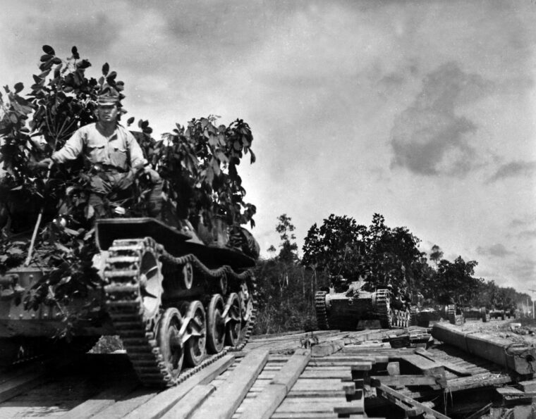 Japanese tanks advance across a bridge toward the town of Johor Bahru during their lightning conquest of the Malay Peninsula. This photo was taken in late January 1942, and within weeks the British bastion of Singapore had fallen to the invaders.
