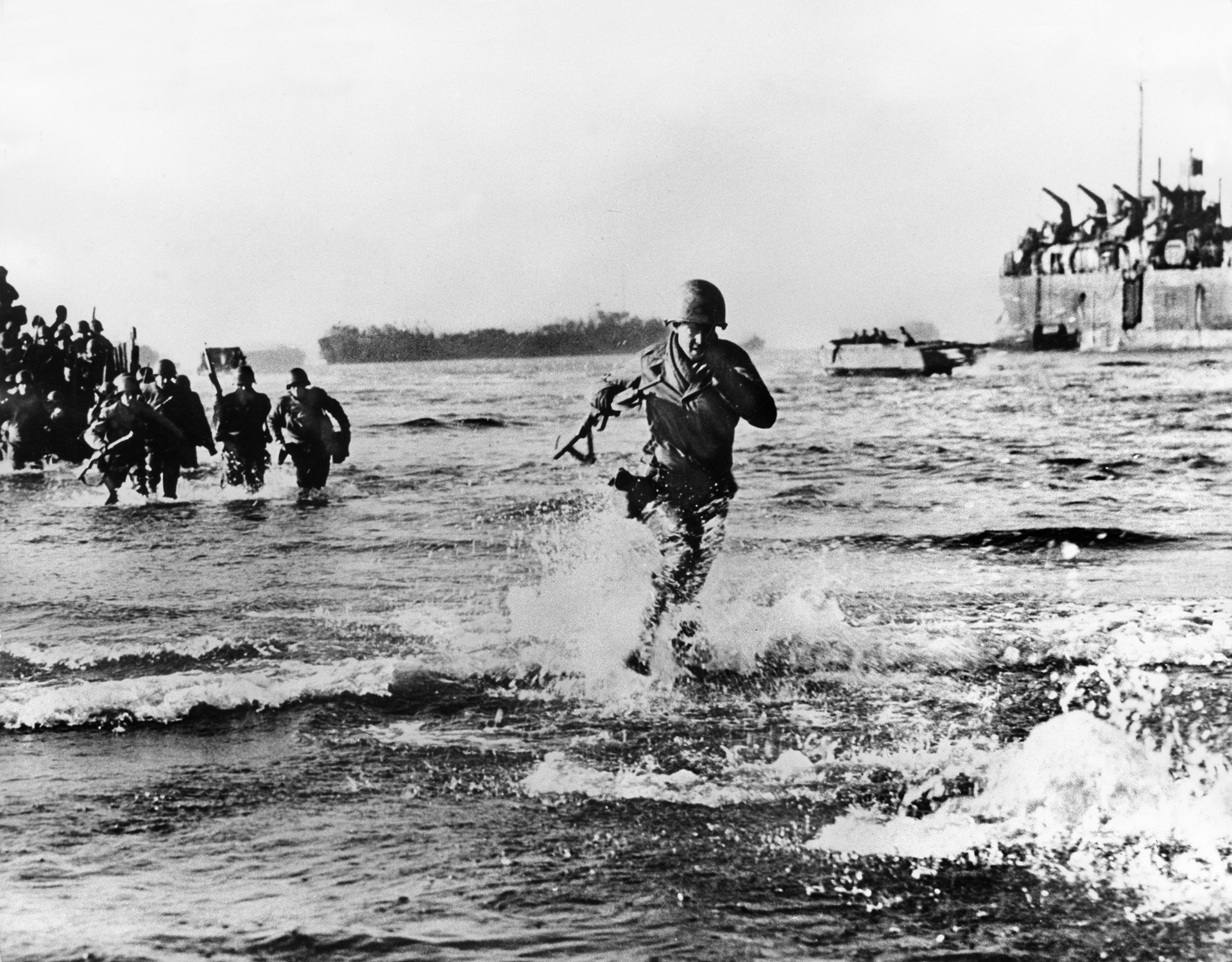 American soldiers splash ashore at Anzio, Italy, during an end run expected to compromise the German defenses of the Gustav Line. The landings failed to achieve the desired results and remain controversial to this day.