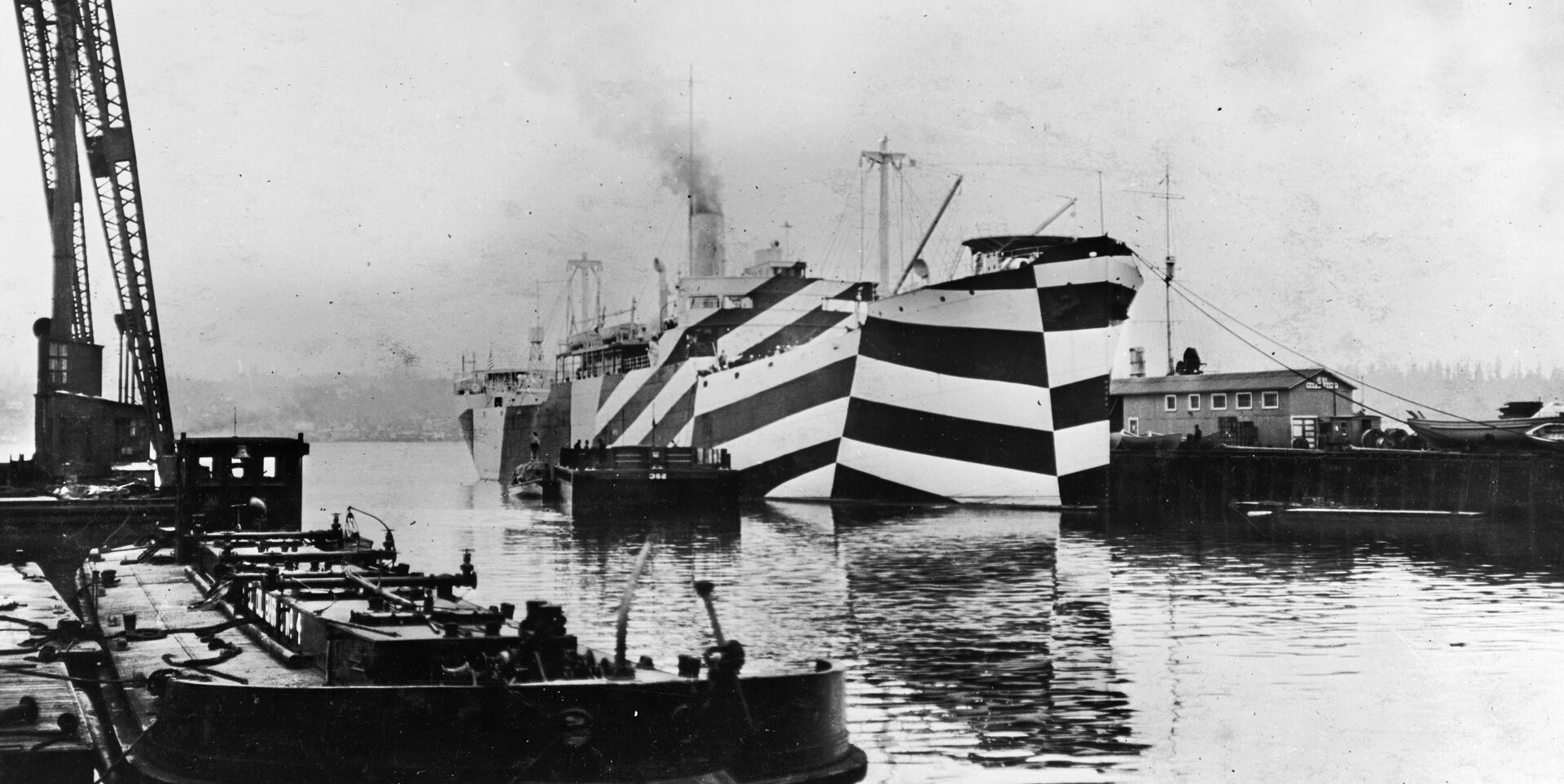 Painted in dazzle camouflage, the USS West Mahomet illustrates how the paint scheme distorts the apparent aspect of the bow. The three-dimensional effect completely fools the eye of an observer, making the ship hard to identify. 