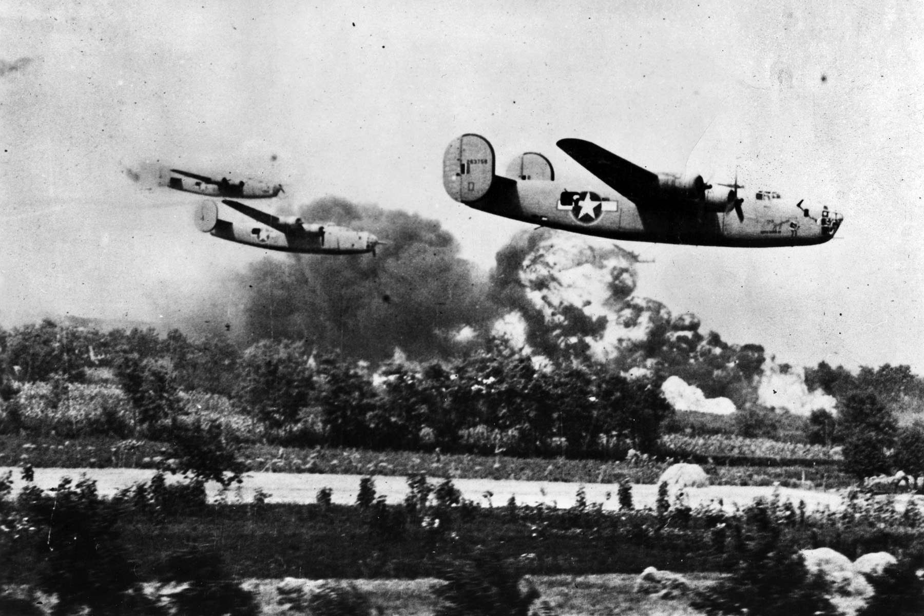 Pilots and crewmen of B-24 Liberator heavy bombers brave enemy fire and fly low toward their target during the costly Ploesti raid. The oil refineries at Ploesti were put out of commission for only a short time as a result of the raid. 