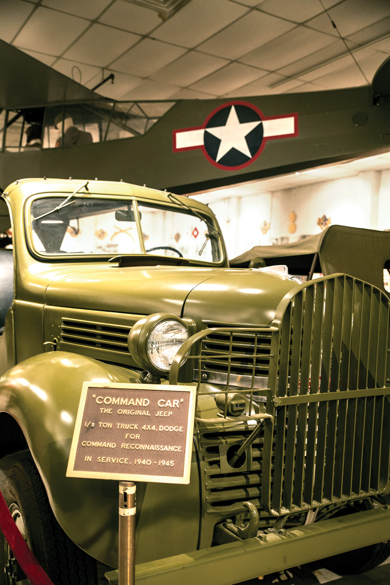  A Piper L-4 spotter plane hangs above a 1940 Dodge command car––one of dozens of vehicles at the museum. 