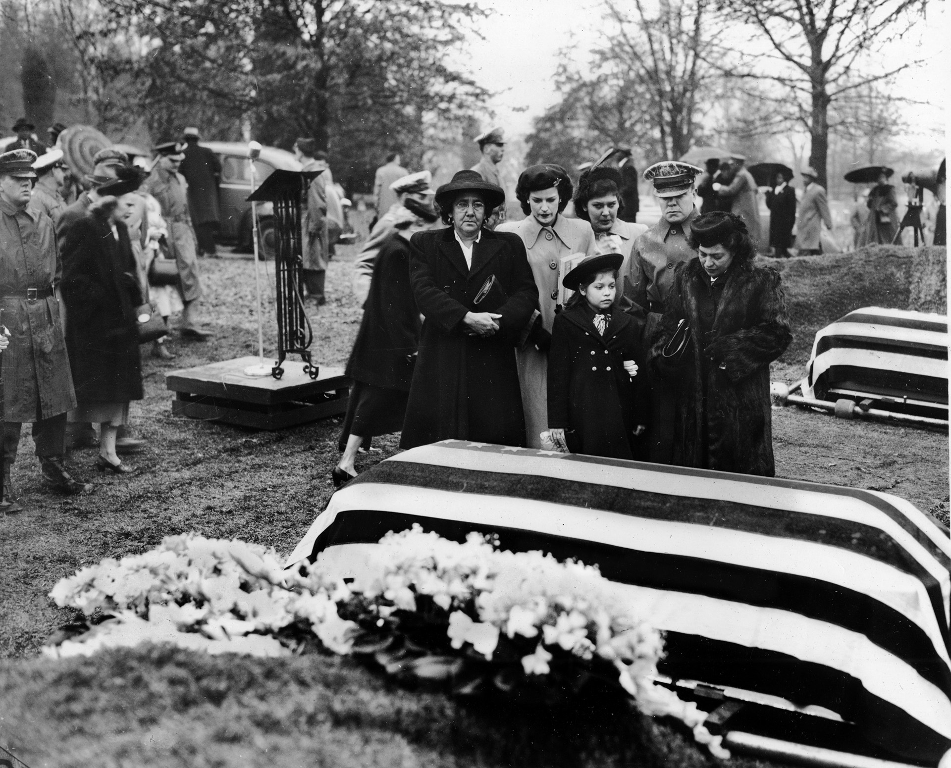 During funeral services for Pfc. Felix Longoria on February 16, 1949, family members pause beside the flag-draped casket. Longoria was buried with full military honors at Arlington National Cemetery after a funeral home in his hometown of Three Rivers, Texas, refused to provide services to the Mexican American family.