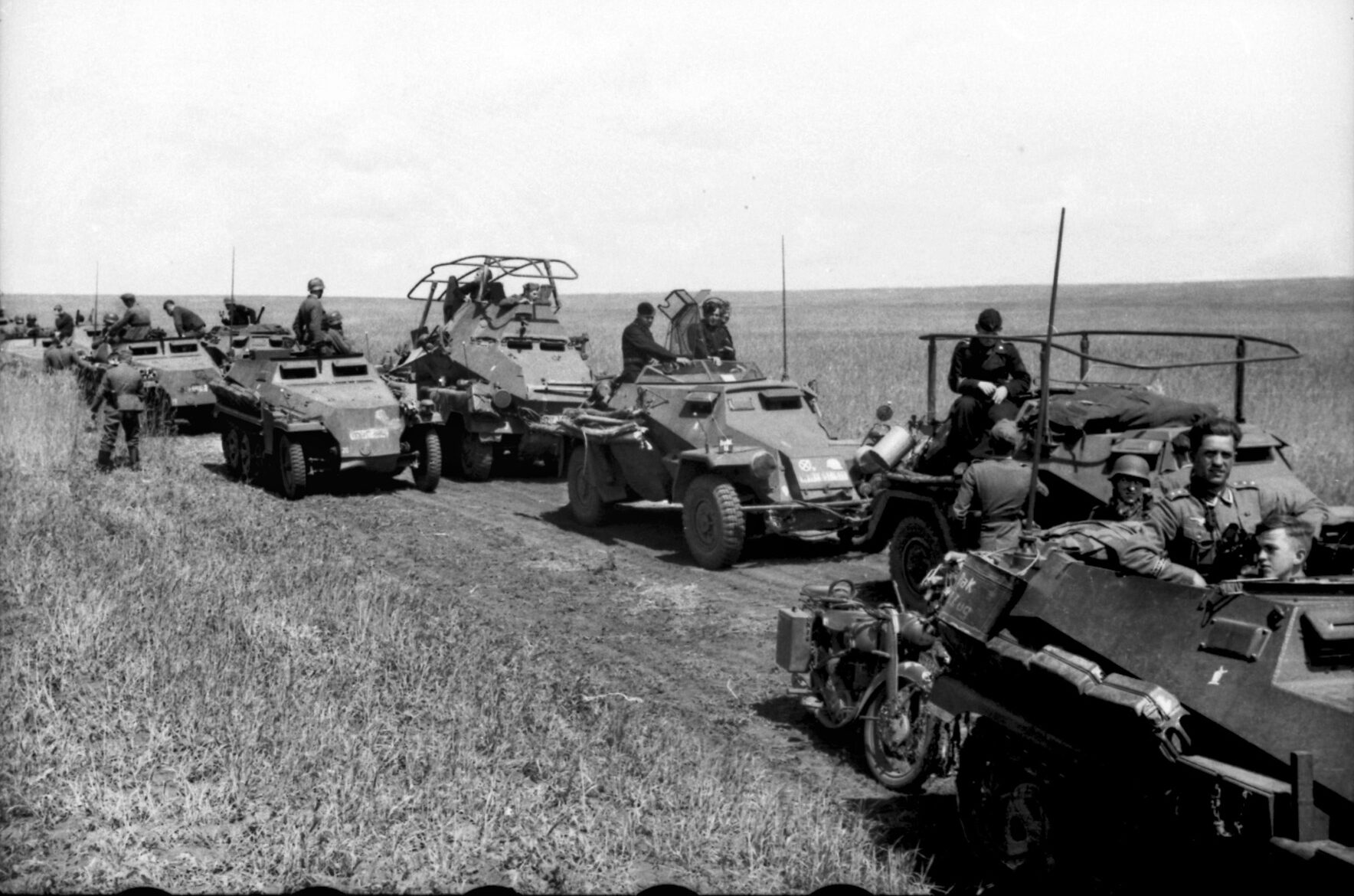 Reconnaissance troops of Panzergrenadier Division Grossdeutschland cross the Ukrainian steppe northwest of Kharkov. Pictured with half-tracks are an SdKfz.222 light armored vehicle and the SdKfz.263 heavy armored command vehicle.
