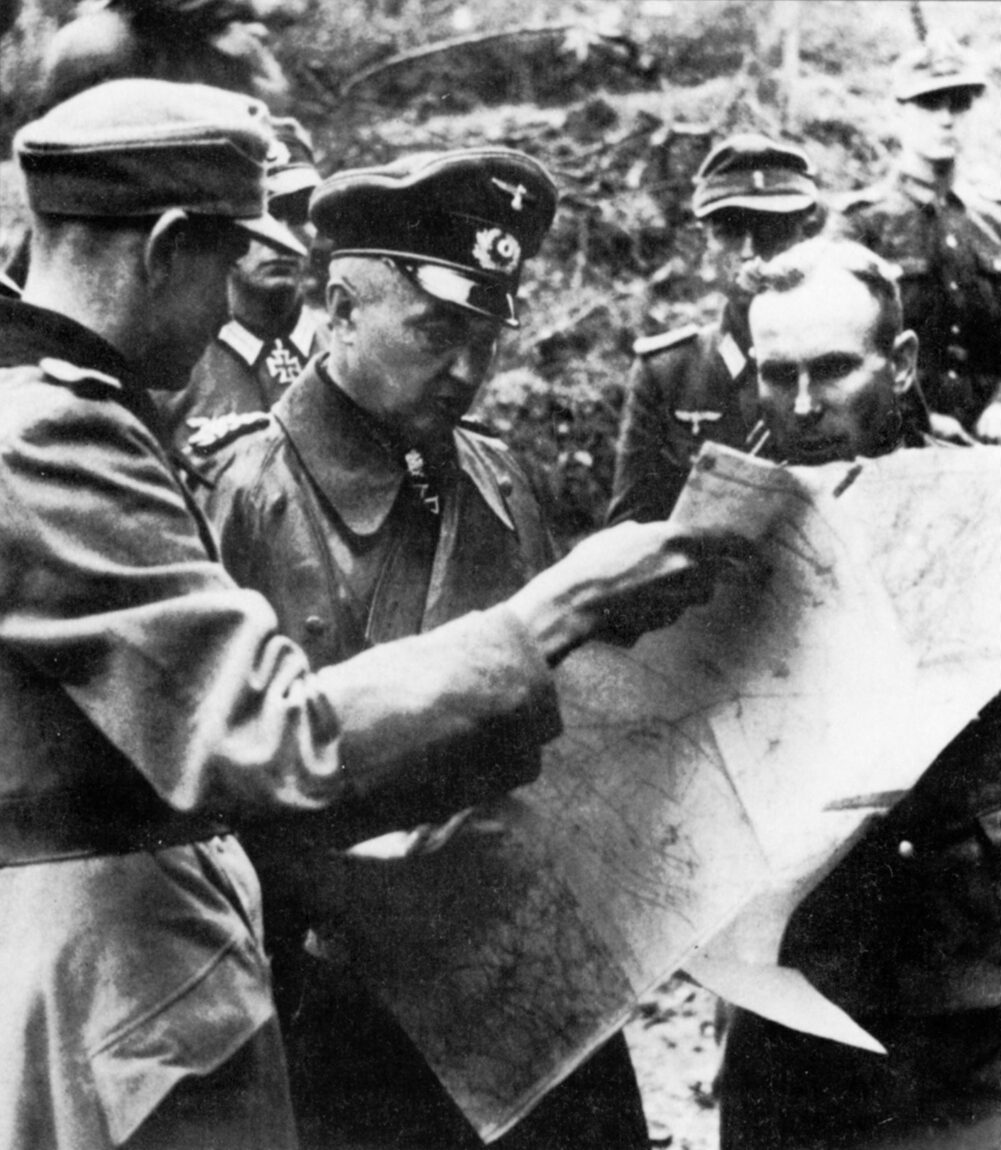 Commander Gerhard Wilck (far right) of the 246th Volksgrenadier Division confers with Field Marshal Walther Model on the defense of Aachen. 
