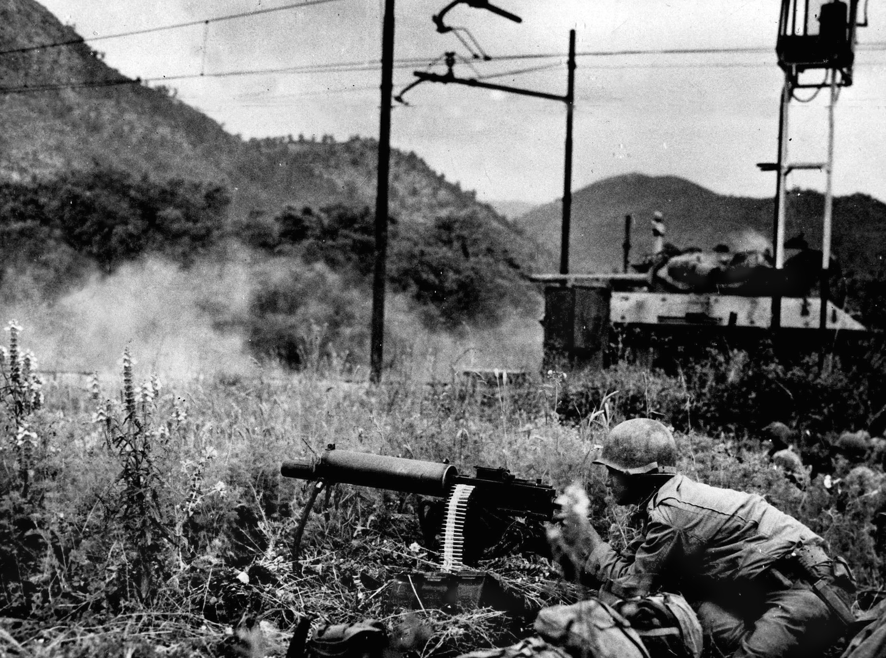 An American soldier fires a .30-caliber water-cooled machine gun at German positions around the Galleria di Monte Orso near Fondi while an M-10 tank destroyer trains its gun on the enemy as well. The performance of General John P. Lucas, commander of the VI Corps at Anzio, was deemed poor, and he was relieved of command.
