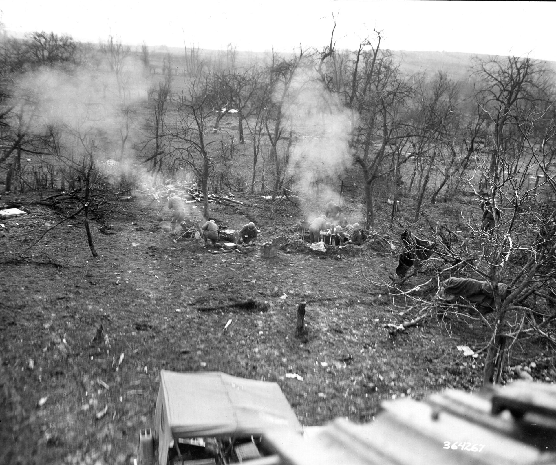 Mortarmen from the 44th Infantry Division, positioned near the 397th Regiment outside Rimling, fire their tubes—including a captured German mortar—on New Year’s Day 1945. Although the 44th's front crumbled, allowing the enemy to flank the 397th, the regiment refused to yield. 