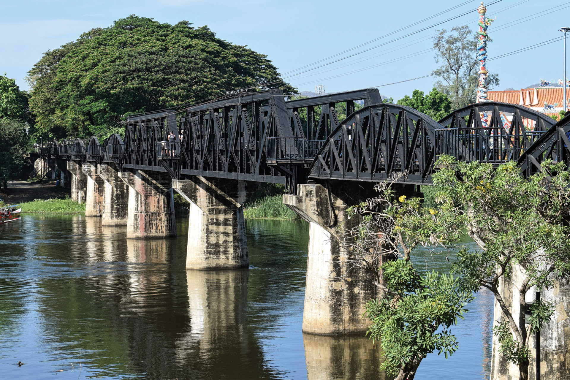 The largely intact Kwai Bridge as it appears today. As there was no actual “River Kwai,” this stretch of the Mae Klong River was renamed Kwae Yai, and is today a popular tourist destination.