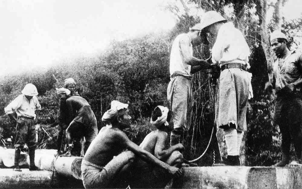 Native laborers building a bridge. Photographed in 1943 at either Songkurai in Thailand or Ronsi in Burma.