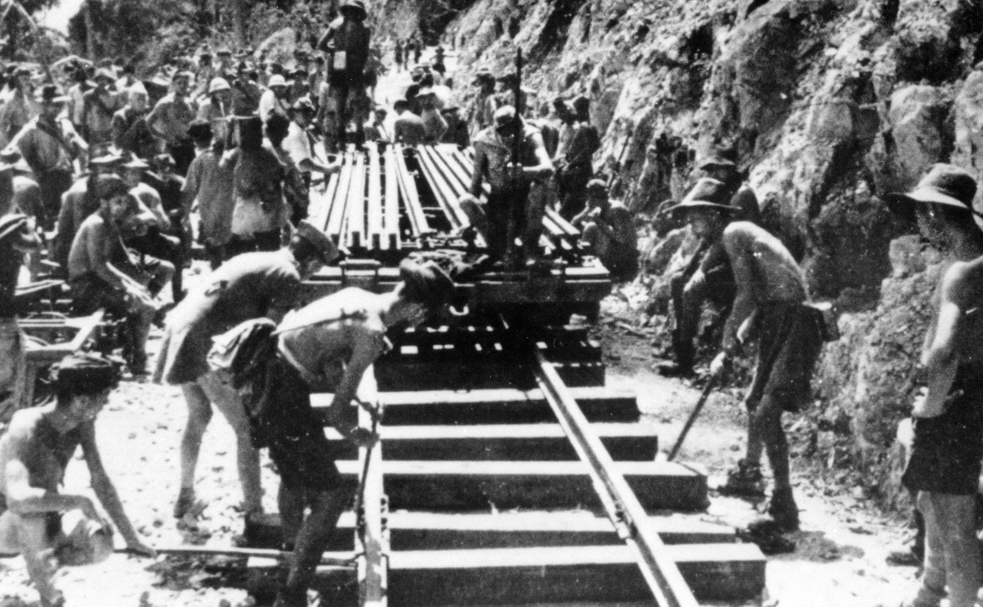 Working under a broiling sun, Australian POWs labor to lay track. Disease and dreadful working conditions—not to mention the brutality of their guards—caused thousands of deaths. Allied warplanes frequently bombed the line, causing further deaths and injuries.