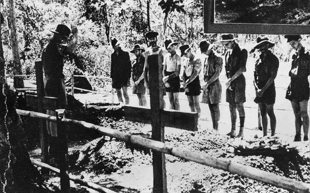 Eight Australian POWs pay their last respects at the burial of a comrade who died during construction of the railroad, 1943.