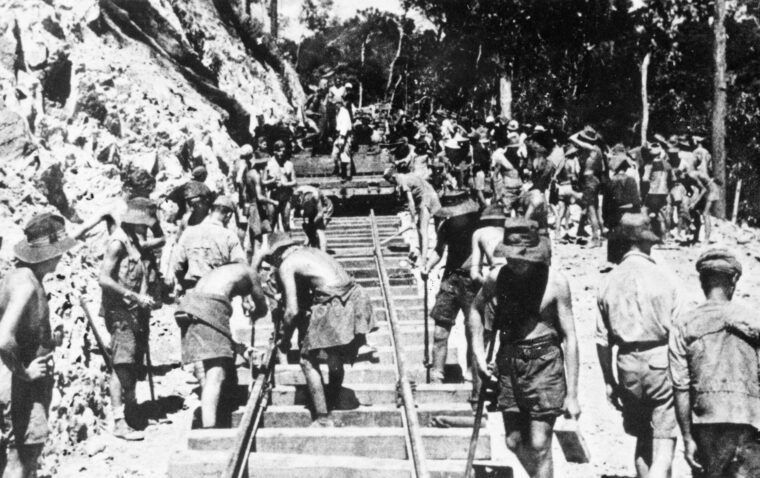 Australian, New Zealand, Dutch, and British prisoners of war lay track on the Burma-Thailand “Death Railway” near Ronsi, Burma, 1943. More than 12,000 Allied POWs and tens of thousands of Asian civilian workers died while working on the line. The Japanese needed the railway to supply Japanese forces in occupied Burma and exploit that country’s natural resources.