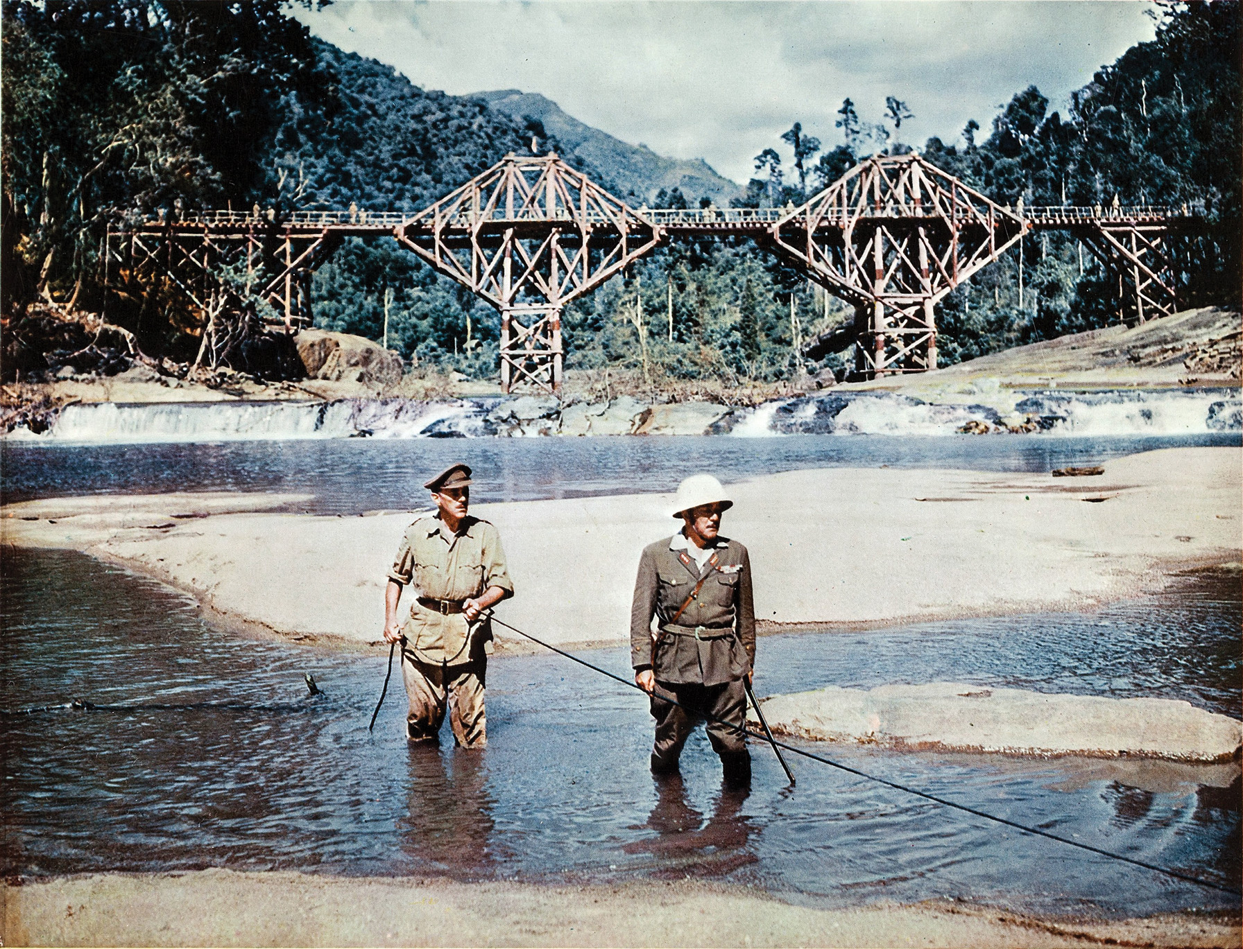 In the climactic scene in the movie The Bridge on the River Kwai, British officer Colonel Nicholson (Alec Guinness, left) leads Japanese Colonel Saito (Sessue Hayakawa) to the detonator primed by the commando team by following the wire that has been exposed by the low water level.