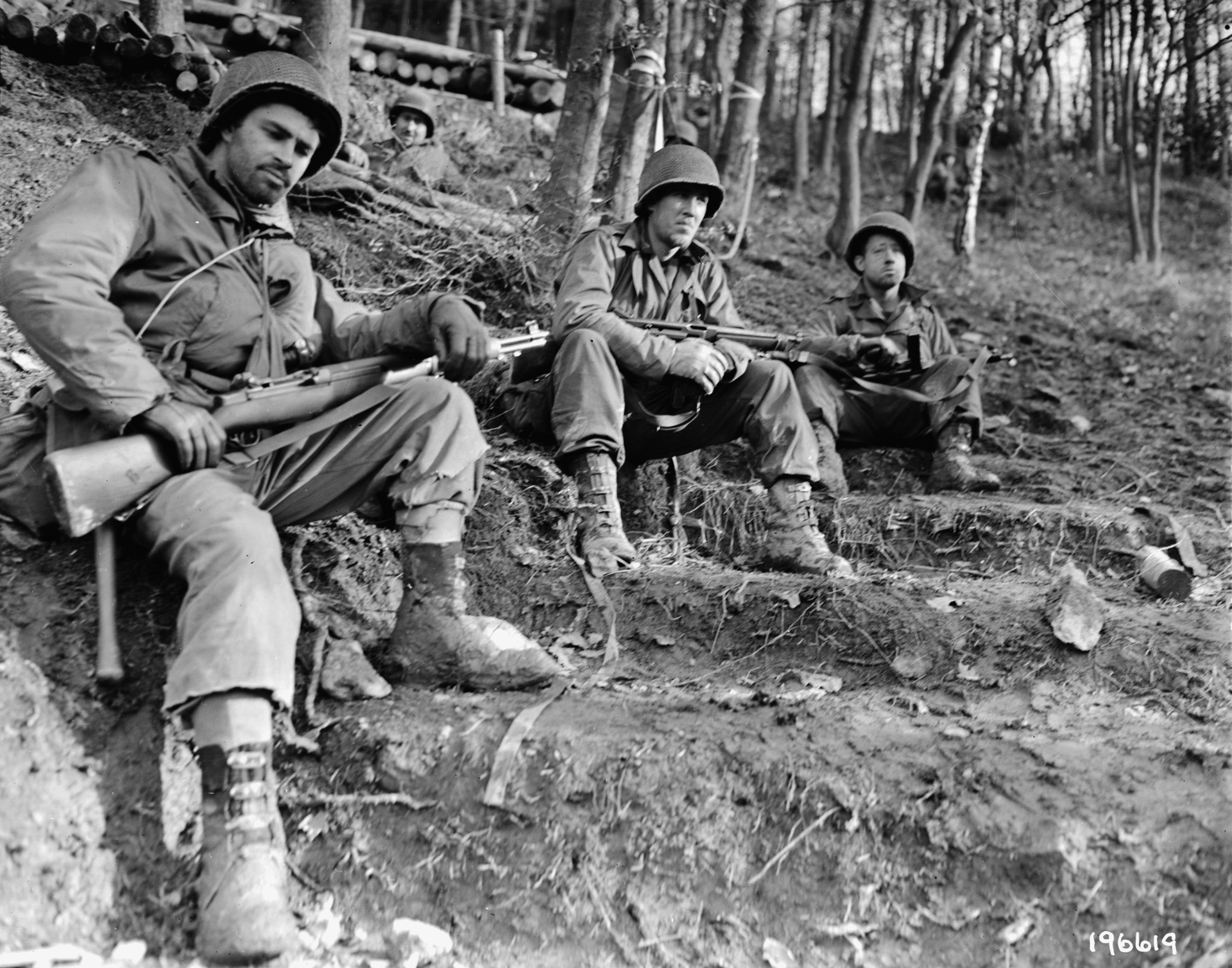 A group of tired and dirty 4th Infantry Division GIs gazes at the town of Schmidt from their hillside positions and ponder the effort that will be needed to take it, November 18, 1944.