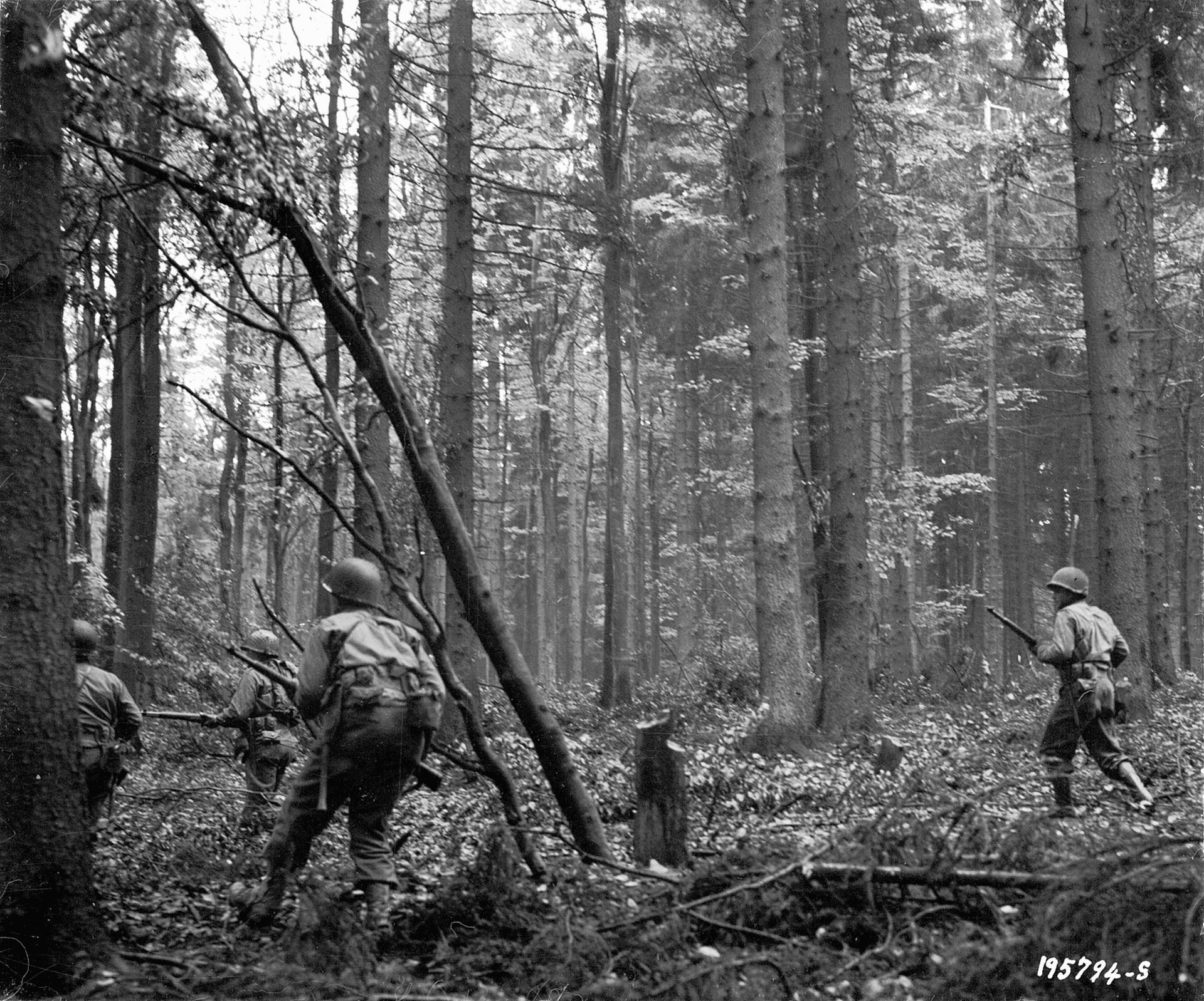 The heavily wooded terrain restricted visibility and mobility. Here a squad of 28th Infantry Division men advances cautiously through the Hürtgen Forest near Vossenack during the attack on Schmidt, November 3.
