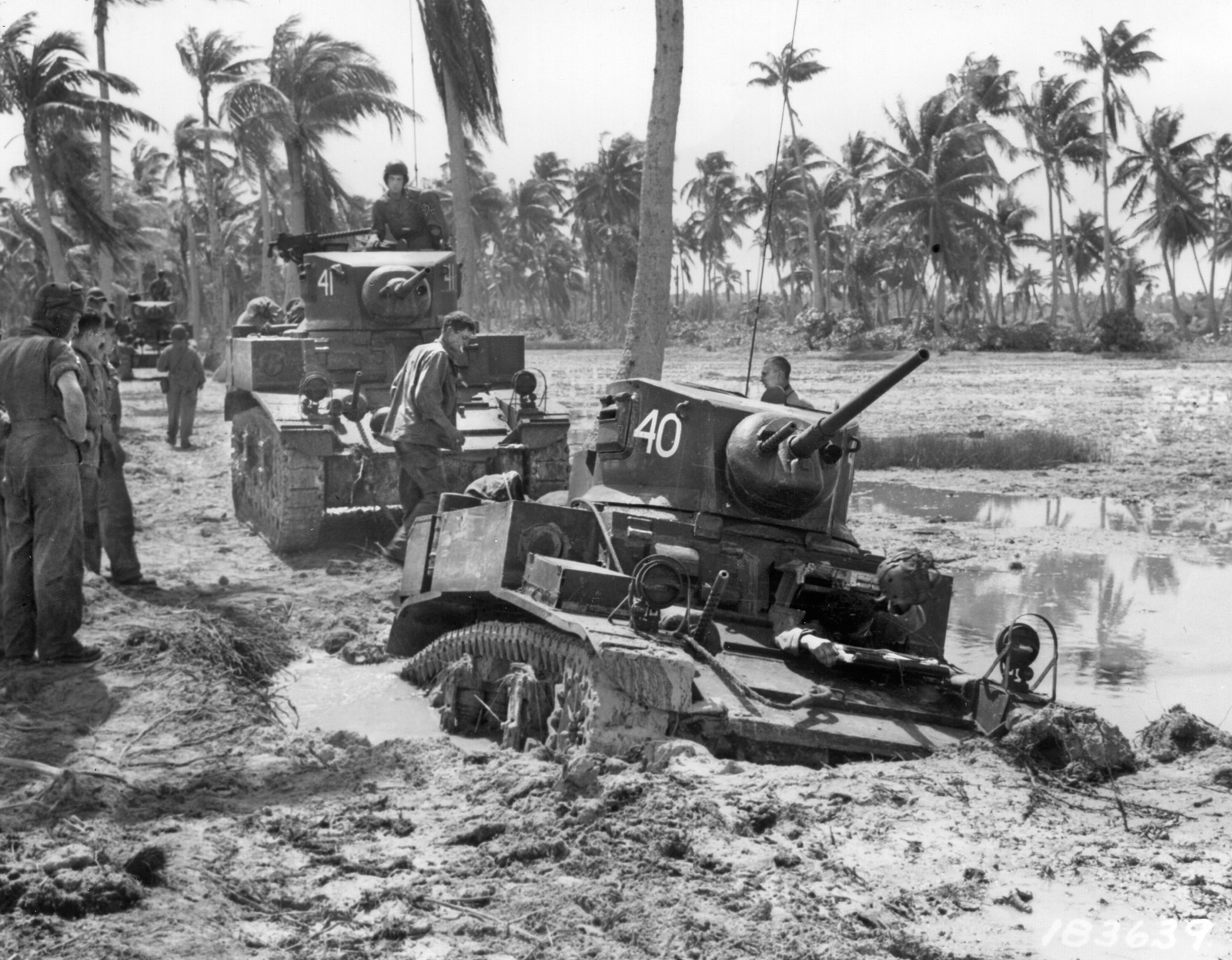 An M3 Stuart light tank of the 193rd Tank Battalion has bogged down in a shell crater on Makin Island while supporting the 27th Infantry Division. The 193rd traded their Stuarts for Shermans before they reached Okinawa.