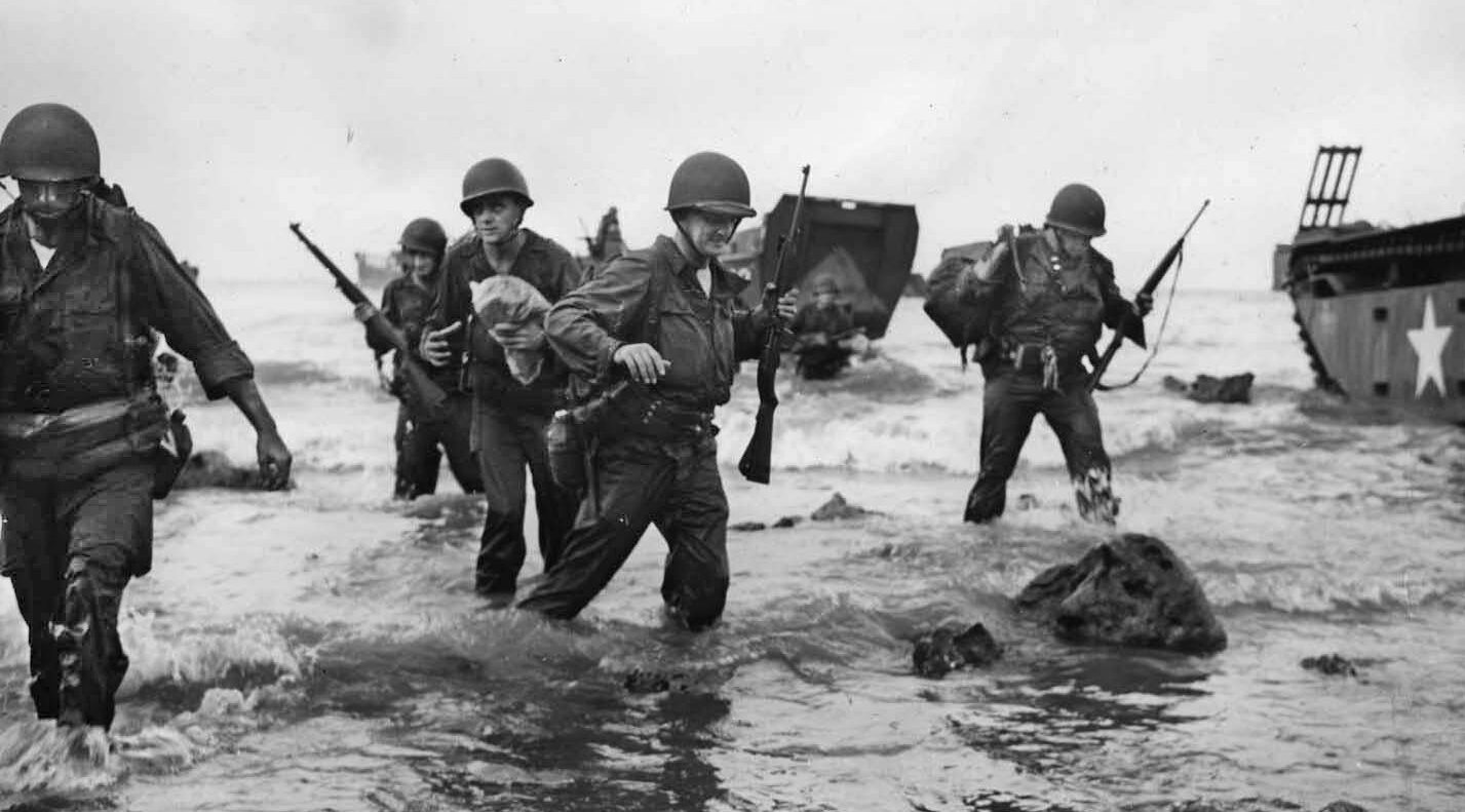 Members of the 27th Infantry Division, a New York State National Guard unit, come ashore on Makin Island, November 1943, to experience their baptism of fire.