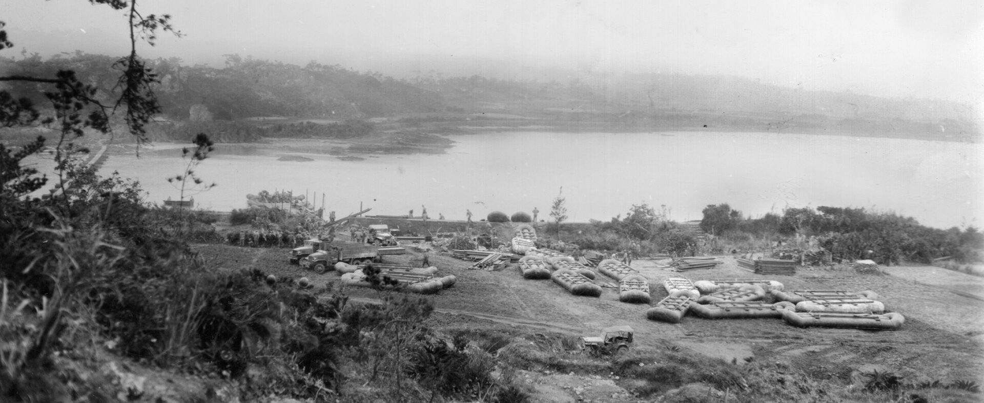 Men of the 102nd Engineer Battalion prepare to build the pontoon bridge that the 27th Infantry Division will use to get tanks and supplies across the Machinato Inlet to attack Kakazu Ridge. 