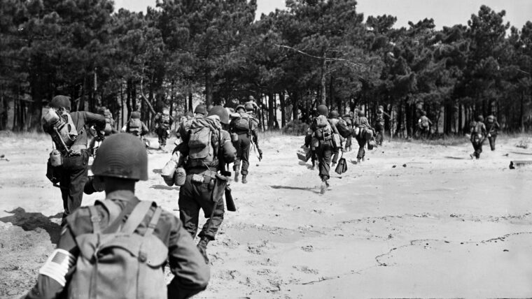 Moments after hitting the beaches of southern France during Operation Anvil-Dragoon in August 1944, these American soldiers sprint toward the cover of a grove of pine trees. These men are loaded with full packs of equipment and provisions for the long fight ahead.