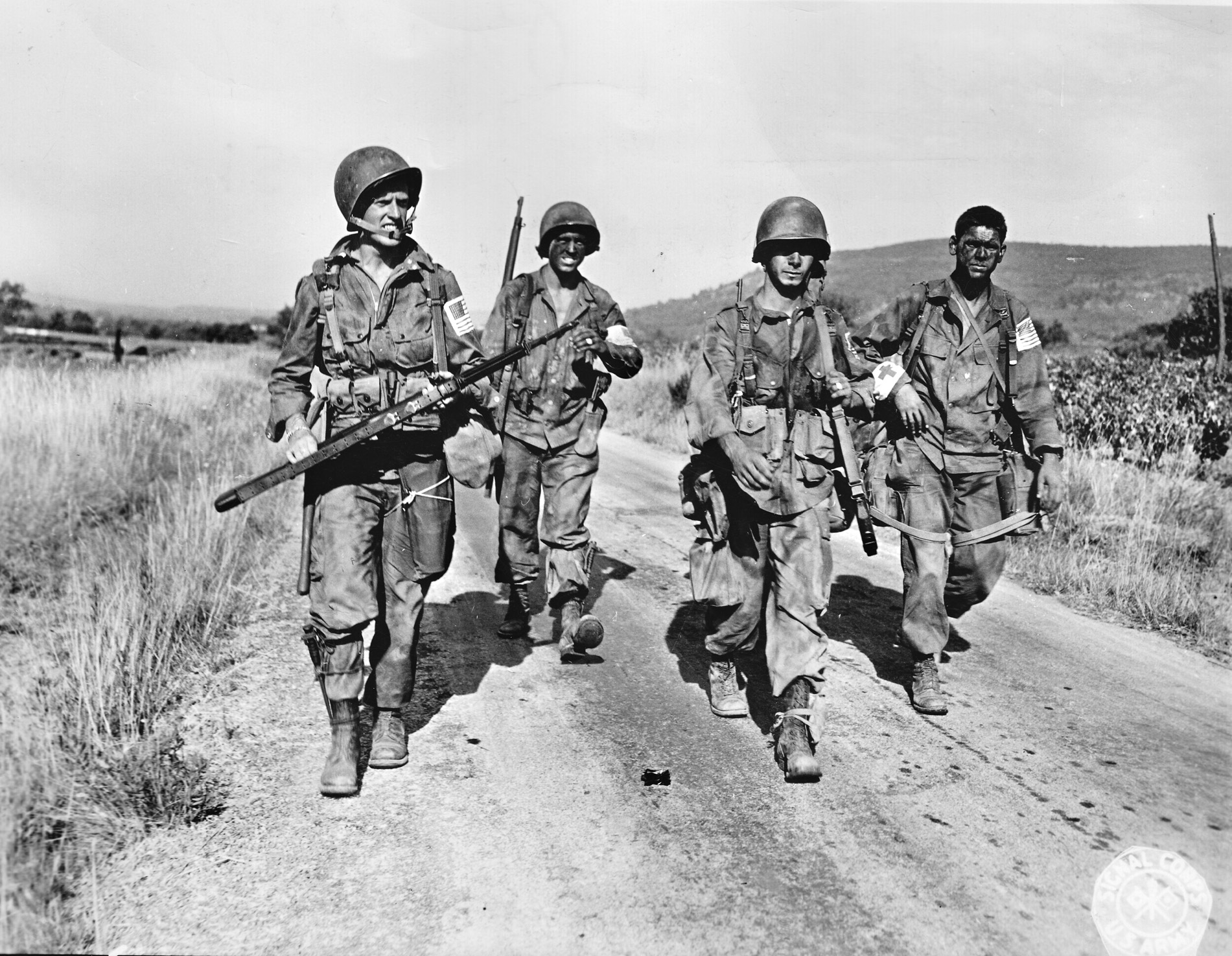 During their successful effort to prevent German reinforcements from reaching the invasion beaches on the southern coast of France, American paratroopers of the 509th Parachute Infantry Battalion rush down Route D7 near the French town of Le Muy.