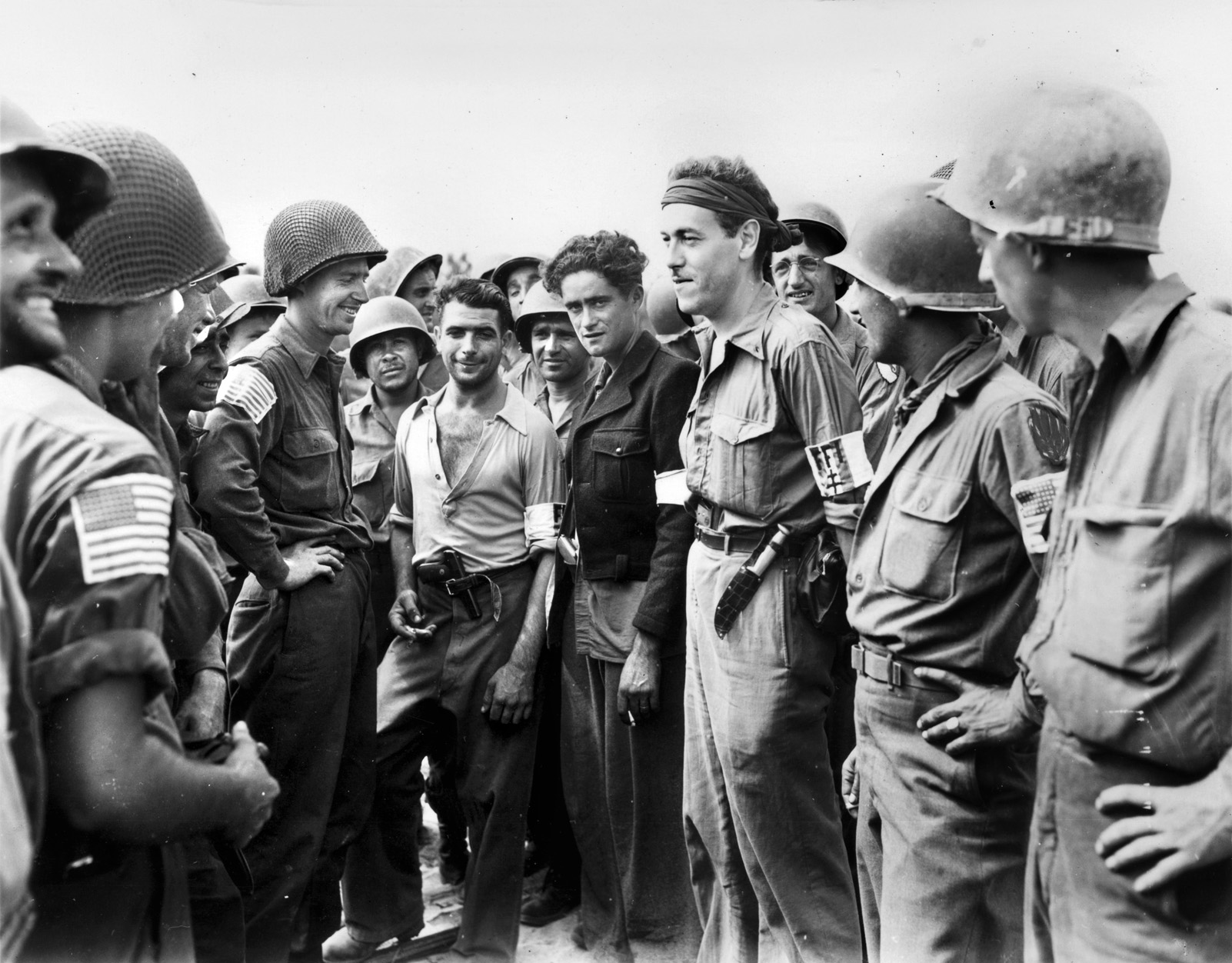 American soldiers greet members of the French Forces of the Interior (FFI), or Maquis, after moving inland from the beaches of southern France during Operation Anvil-Dragoon. 