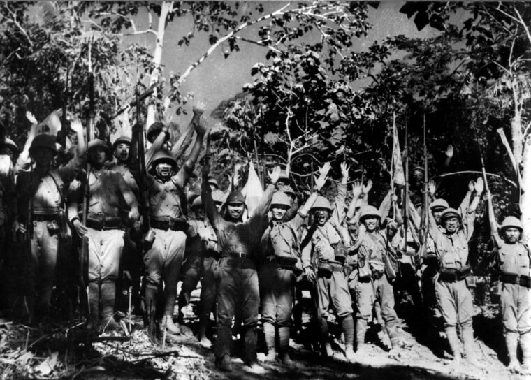 Japanese soldiers on the main island of Luzon celebrate their victory over the Americans and Filipinos, April 1942.