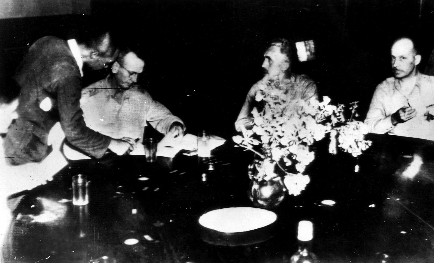To complete the humiliation, Wainwright (left) and Galbraith (center) are forced to make a radio broadcast from Manila declaring the American surrender, May 8, 1942.