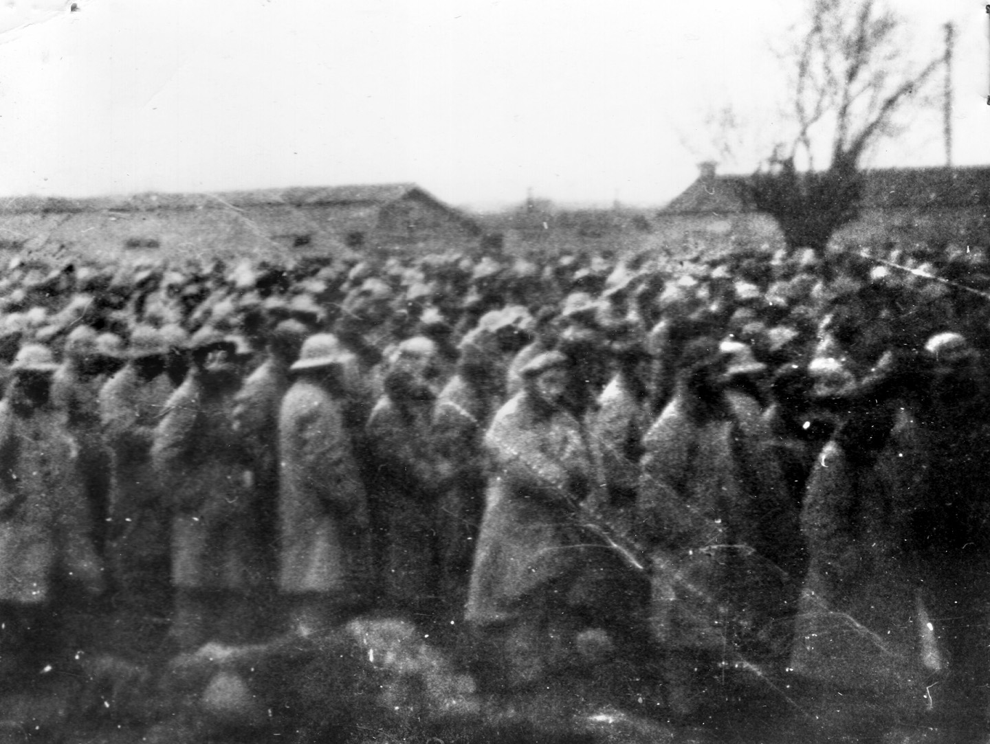 Bundled-up prisoners at roll call on the parade ground at Camp Hoten. 