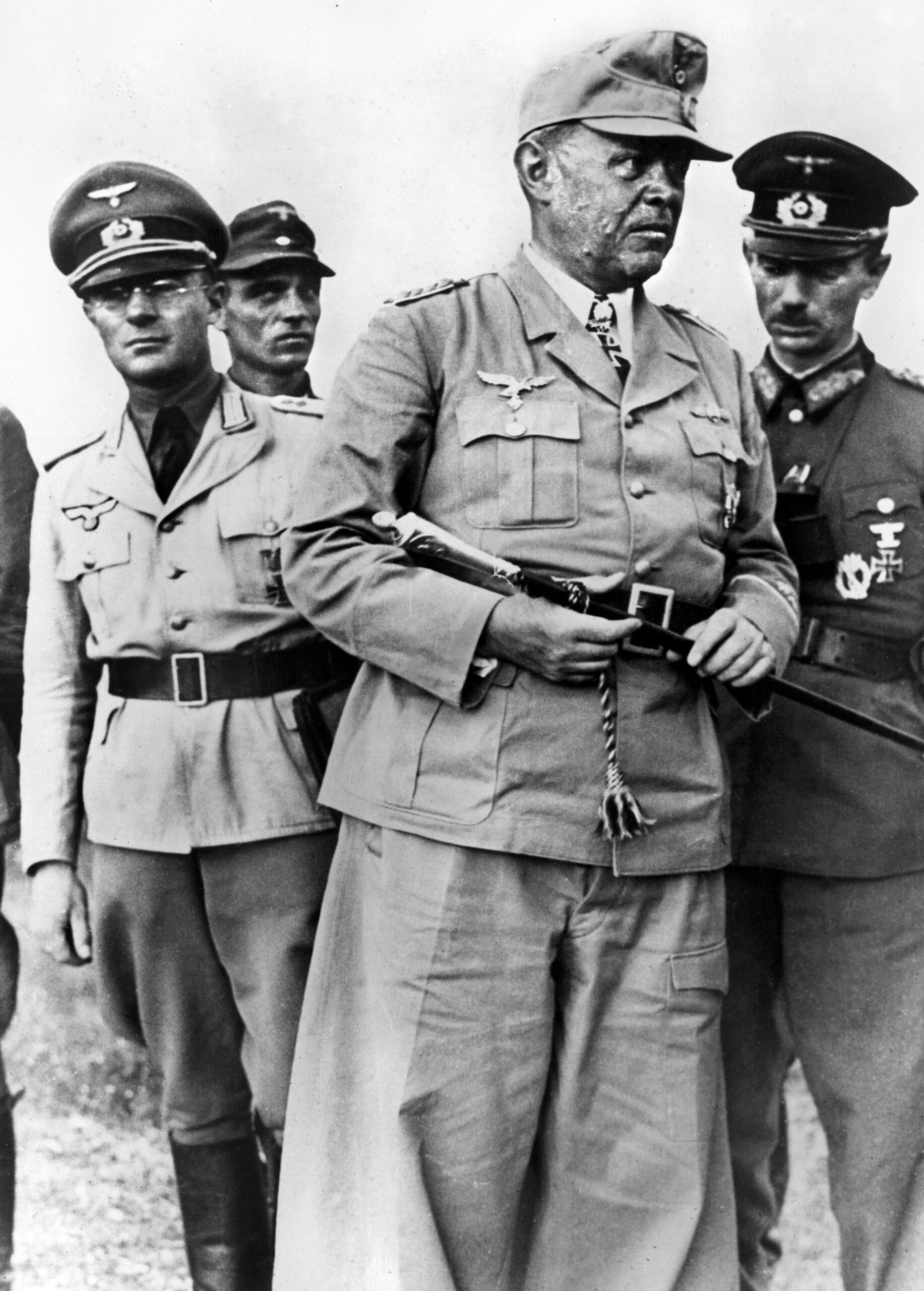 German Field Marshal Albert Kesselring is accompanied by staff officers during  an inspection of defensive positions in Italy in 1944. Kesselring was a Luftwaffe  officer who proved particularly good at managing a defensive ground war in the Mediterranean Theater of Operations.