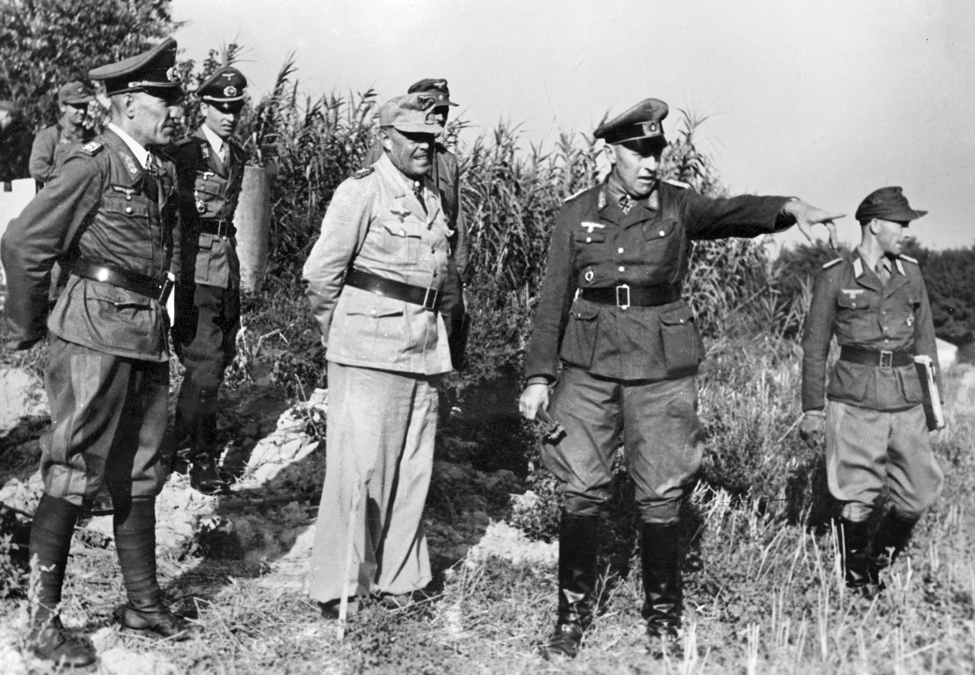 A staff officer points to a location among the German defenses in Italy in October 1944 as Field Marshal Albert Kesselring, commander of German forces in Italy, looks on during an inspection tour. Kesselring skillfully managed a fighting defense, delaying the fall of Rome for months.