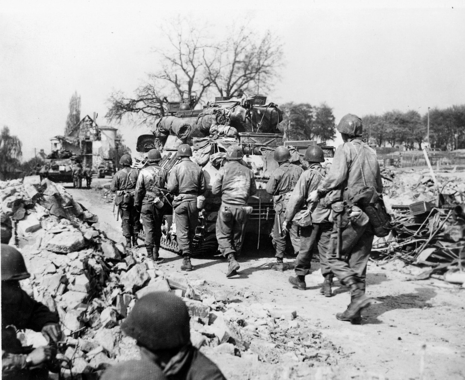 Advancing warily, soldiers of the 3rd Infantry Division take cover behind armored vehicles against potential incoming German fire. The 3rd Division and soldiers like Larimore compiled an impressive combat record during World War II.