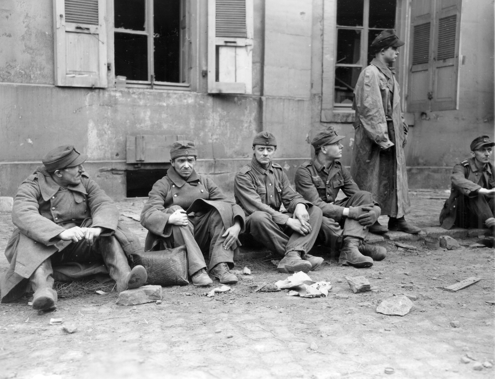 German soldiers captured when 3rd Division troops secured a town sit streetside and await instructions from their captors. These men were sniping at the Americans and were lucky to survive. 