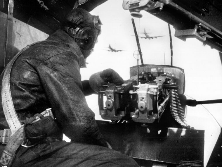 The bombardier of a Boeing B-17 Flying Fortress bomber mans the .50-caliber machine gun in the plane’s nose and scans the skies for German fighters as the formation enters hostile airspace. The Münster raid of October 10, 1943, proved costly for the Eighth Air Force in both men and aircraft.