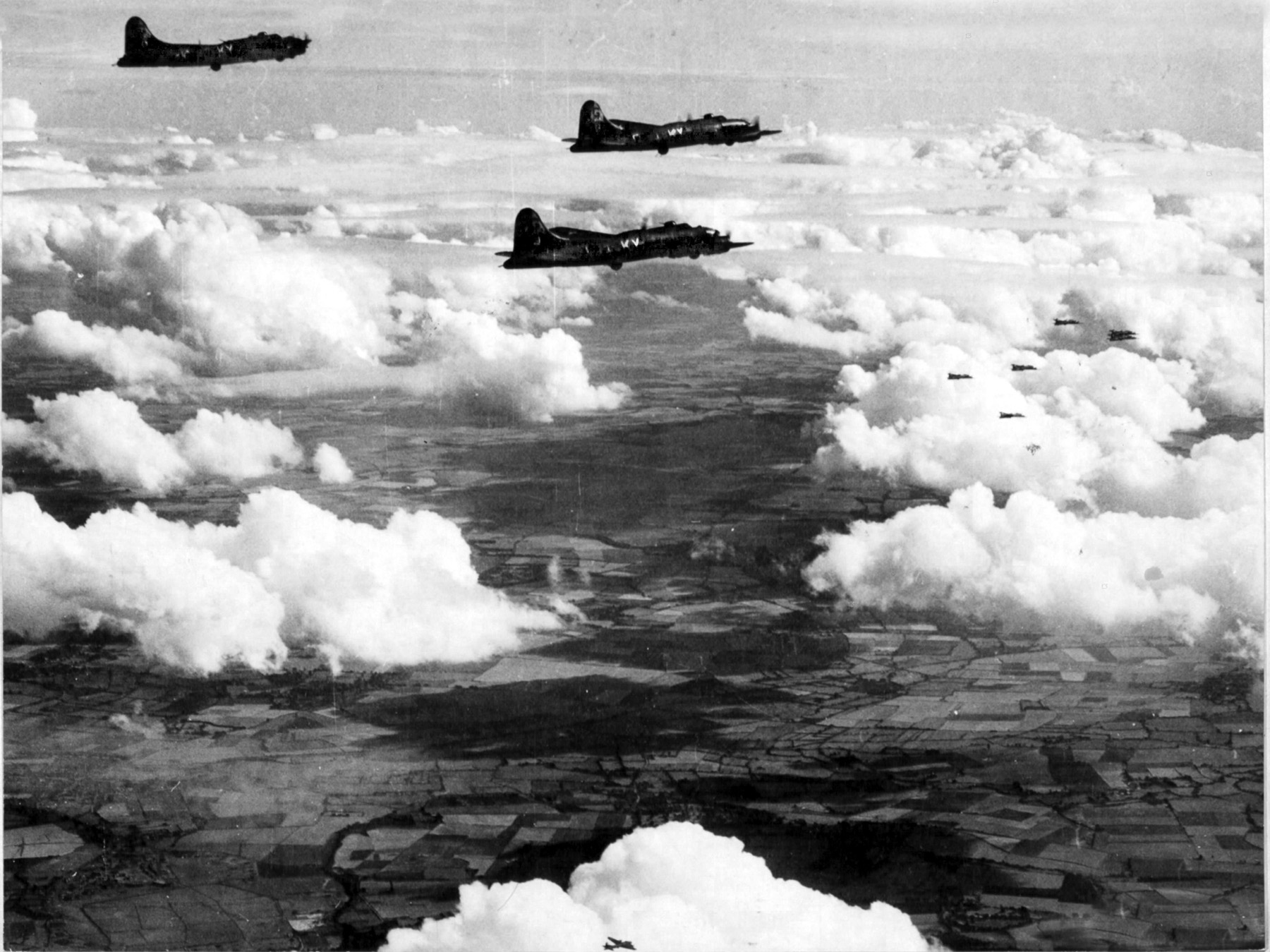 B-17 Flying Fortress heavy bombers of the 350th Bomb Group are shown in flight during an August 1943 mission to bomb German airdromes near Paris. The B-17s were escorted in this mission by Republic P-47 Thunderbolt fighters that tried to keep the Luftwaffe at bay. 