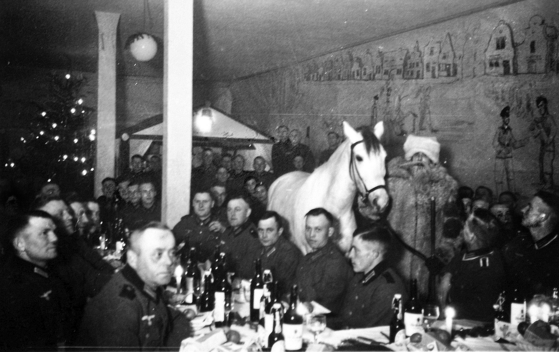 Although the faces of the soldiers appear less than festive, Father Christmas (standing, right) has brought his horse to a holiday dinner party, the table laden with bottles of wine, beer, and liquor, the walls decorated with the soldiers’ artwork. Preparing for war in 1939 the German military counted some 2,740,000 men in uniform, 183,000 motor vehicles, 94,000 motorcycles, and 514,000 horses.