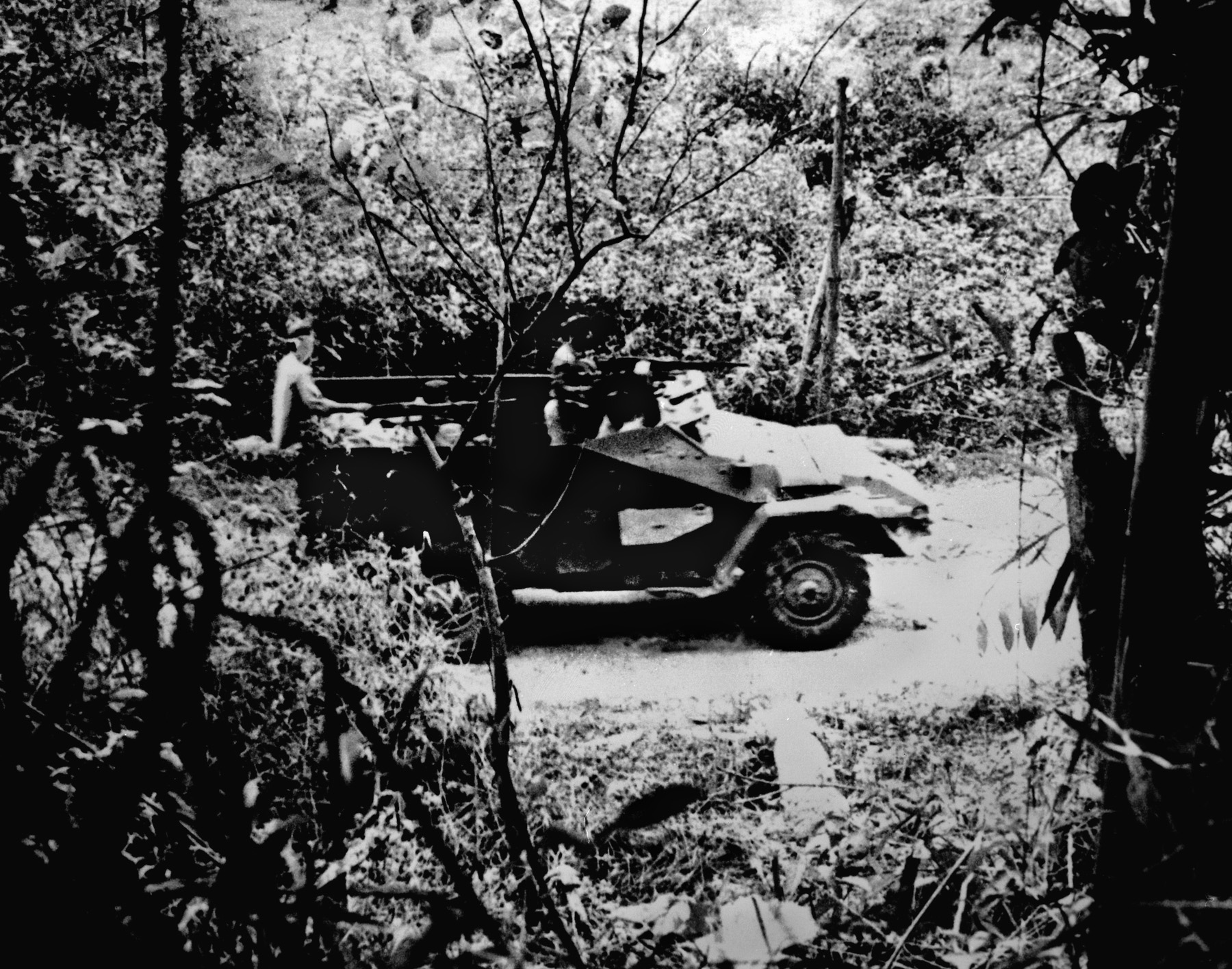 A North Vietnamese armored vehicle moves along the Ho Chi Minh Trail. Hanoi’s initial response to the raid was gradual because it believed North Vietnam was in danger of being attacked either across the demilitarized zone or from the sea by an amphibious landing.