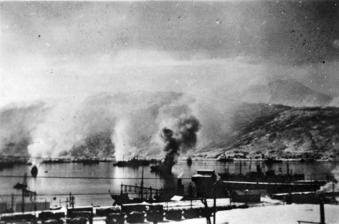 Damaged German ships belch smoke skyward after the dawn attack by British destroyers on April 10. The surprised German sailors at first believed they were under aerial attack, but soon got their bearings and returned British destroyer gunfire.