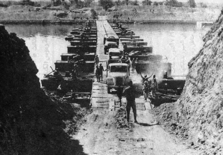 Egyptian forces cross the Suez Canal on the second day of the war. Instead of establishing a single bridgehead, the Egyptians chose instead to establish a 100-mile-long, shallow bridgehead to force the Israelis to disperse their efforts along the entire front.