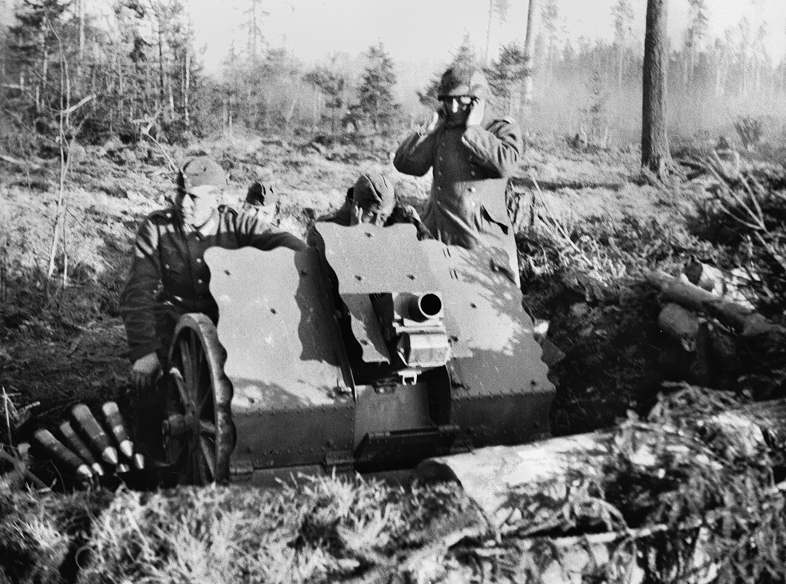 Four soldiers pose for a staged photo with their 75mm (7.5 cm) light infantry howitzer in the Lake Ladoga area during the summer of 1943. 