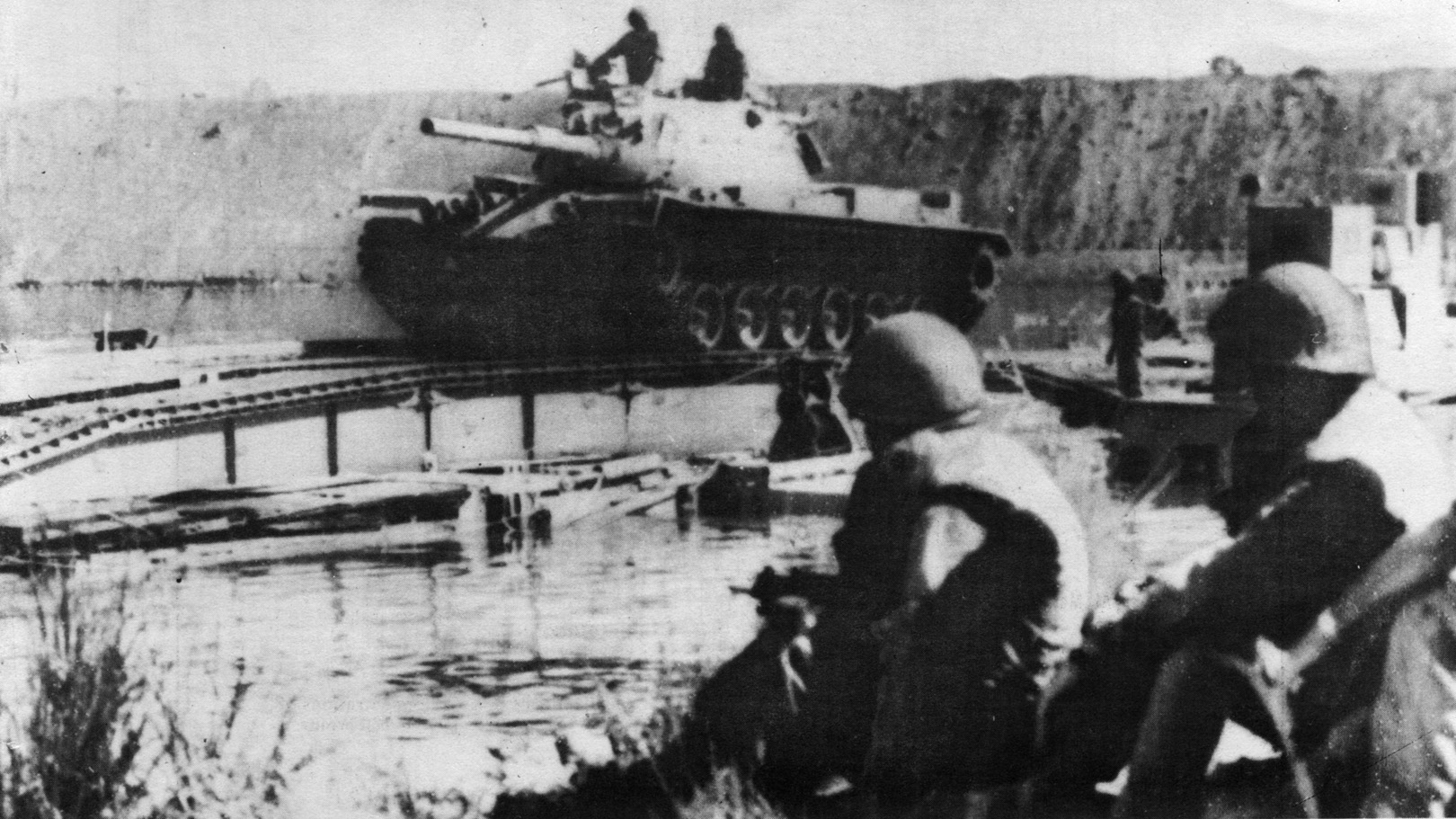 An Israeli tank rumbles across the preconstructed roller bridge over the Suez Canal. The Israeli victory in the Battle of the Chinese Farm gave them control of the roads needed to launch an offensive across the Suez Canal but at a heavy cost in lives and equipment. 