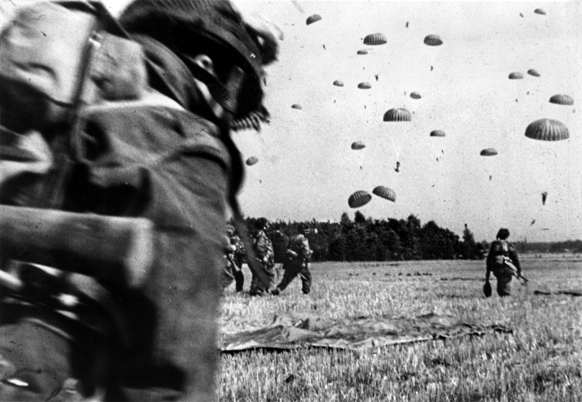 British paratroopers of the 1st Airborne Division, who were tasked with the highway bridge over the Nederrijn at Arnhem, land in an open field at the outset of Operation Market Garden.