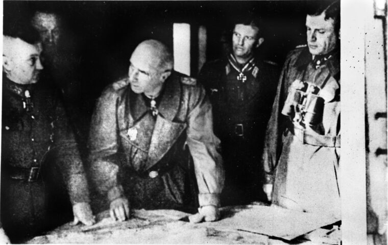 Senior German officers plot a coordinated response to the Allied offensive designed to outflank the Siegfried Line. From left to right are Field Marshal Walter Model, Generaloberst Kurt Student, SS General leutnant Wilhelm Bittrich, Major Hans Peter Knaust, and SS Generalleutnant Heinz Harmel.