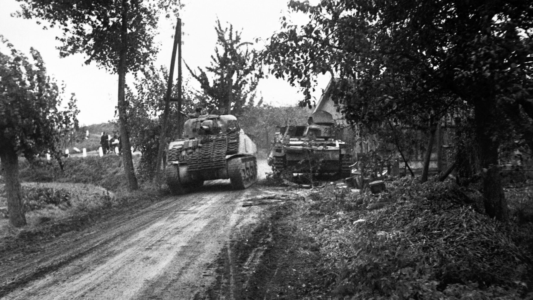 British and German armor clashed on the approach to Nijmegen 12 miles south of Arnhem. Pictured is a Sherman tank of the British 4th/7th Royal Dragoon Guards passing a knocked-out Panzer III. 