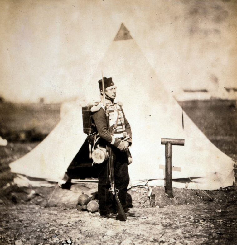 A British Army soldier of the 23rd Foot (Royal Welch Fusiliers) is shown with rifle, canteen, and knapsack. The regiment fought in the battles of Alma, Inkerman, and Sevastopol.