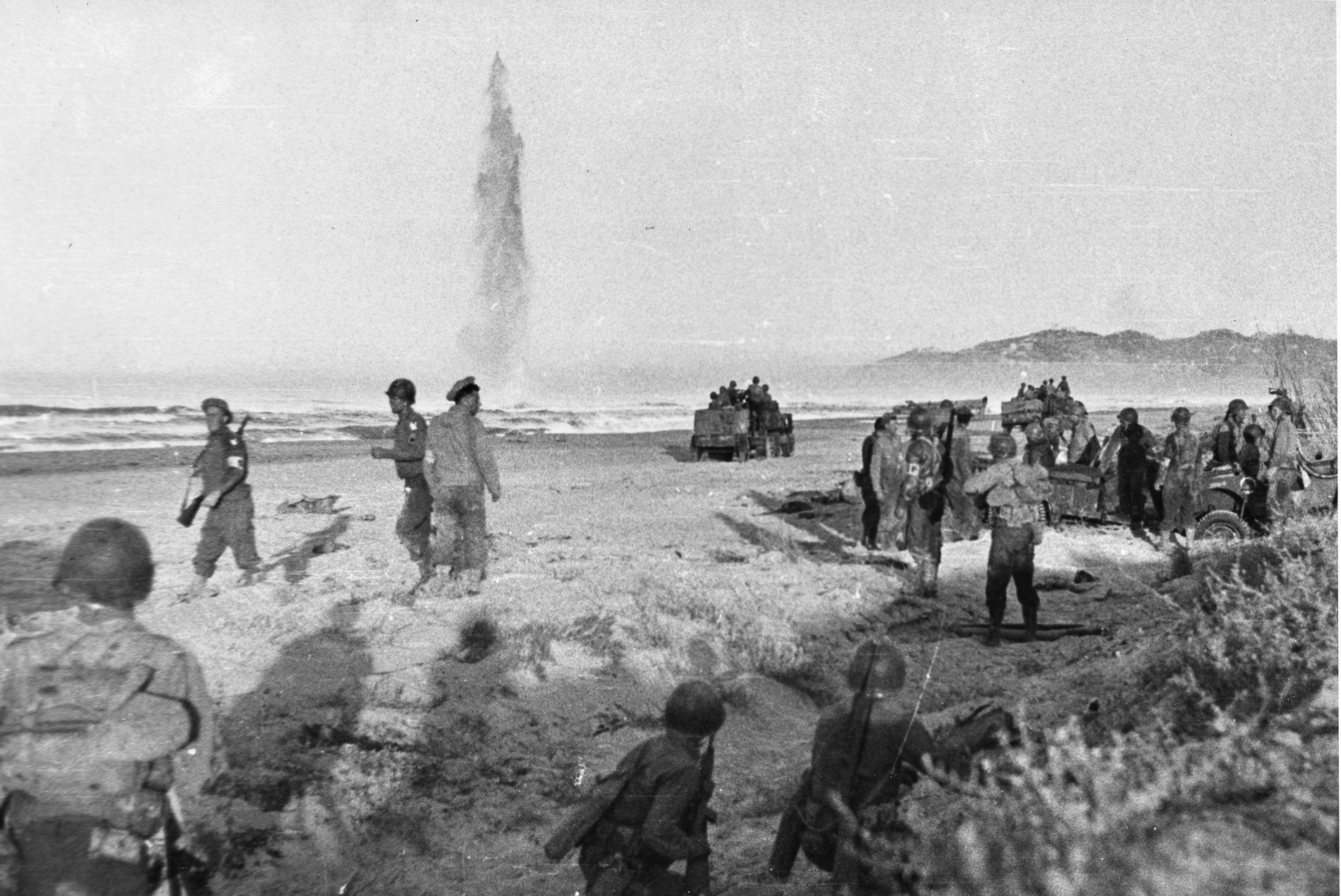 Americans land on the beaches of Sicily under enemy fire. A total of four British and three American divisions landed along a 100-mile strip of the island’s southern coast. 