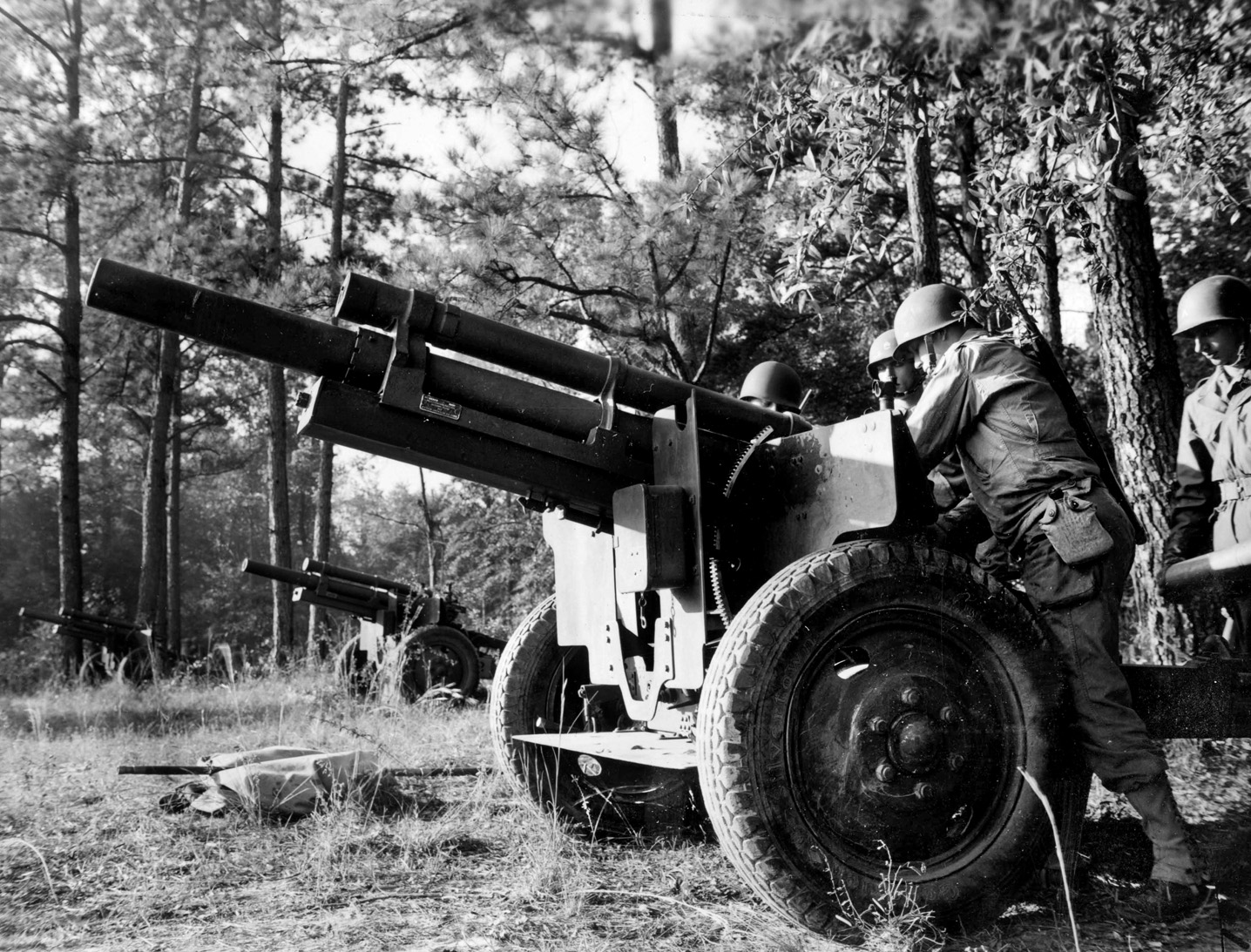 A 105mm howitzer of the U.S. Army is serviced during training exercises. The field artillery pieces assigned to the 106th Infantry Division during the Battle of the Bulge were difficult to relocate due to the slick roads and wintry conditions.