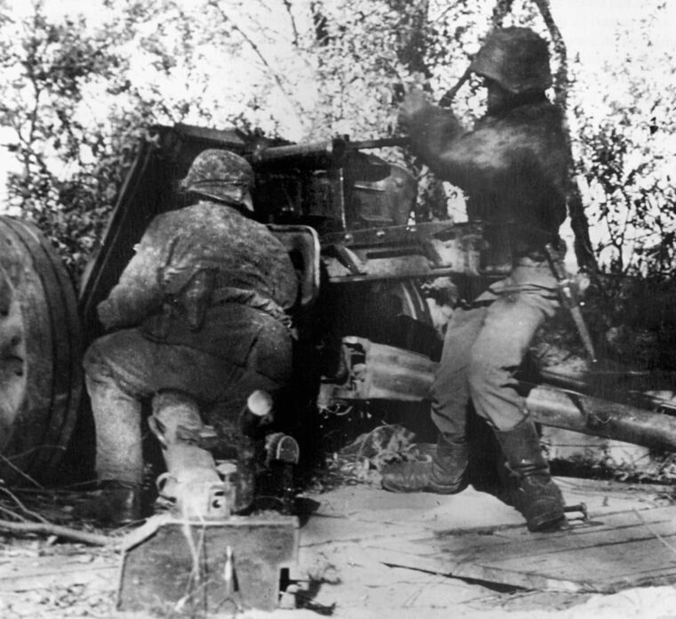 Covering the withdrawal of German forces through a gap at Falaise, artillerymen of the 12th SS Panzer Division “Hitler Jugend” service their weapon. The Germans held desperately to the shoulders of the Falaise Pocket and thousands managed to avoid capture.