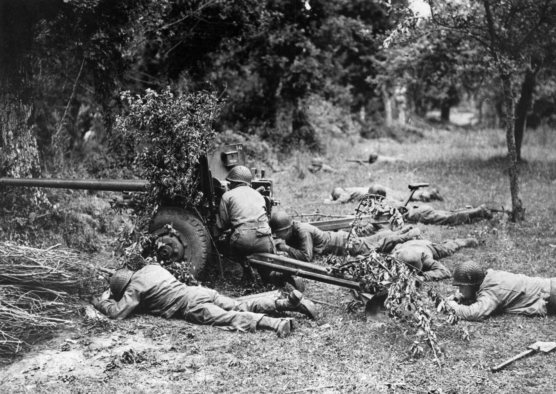 American troops fire a 57mm anti-tank gun at a distant target during action at Falaise. Captain Koob’s Antitank (AT) Company was in position to fire on the Germans as they retreated east from Argentan.
