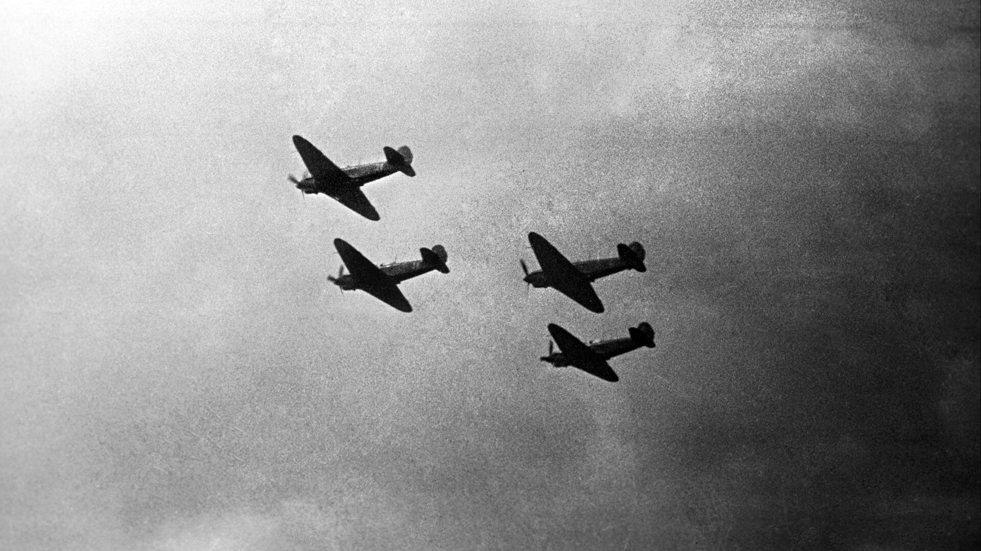 Four Yakovlev fighters of the Normandie Niemen fly in close formation in the skies over the Soviet Union.